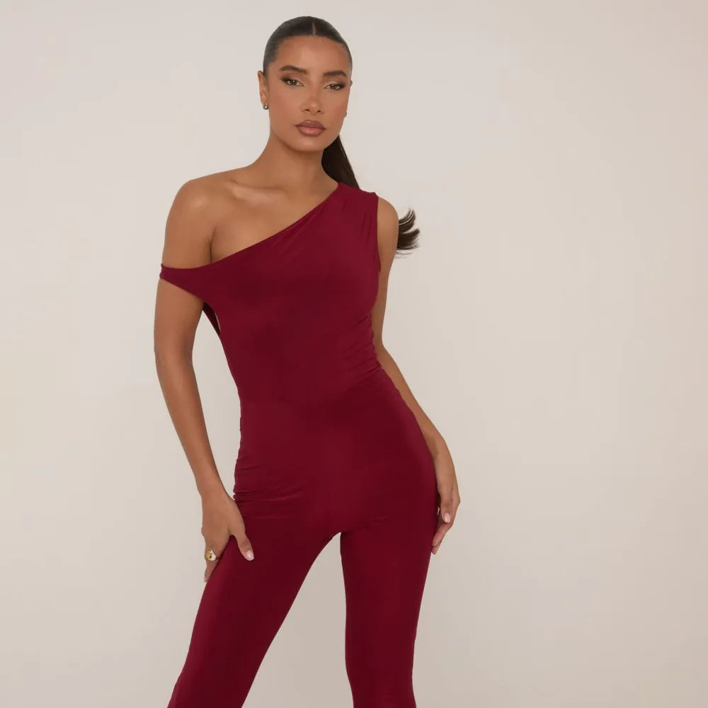 Asymmetric Shoulder Flared Jumpsuit In Burgundy Slinky