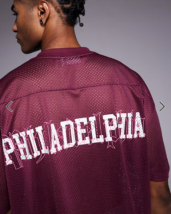 ASOS DESIGN boxy oversized T-shirt with dropped shoulder and v neck with sports graphic in burgundy airtex .