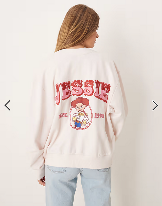 ASOS DESIGN Disney Pixar oversized cardigan with Jessie Toy Story print in pink